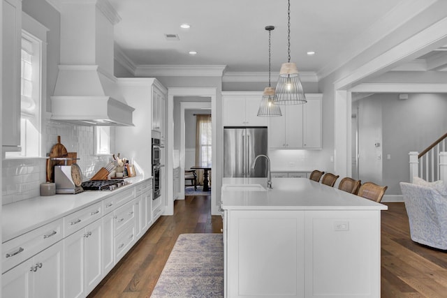 1098 Reserve Ln, Awendaw, SC 29429 - kitchen featuring stainless steel appliances, wall chimney exhaust hood, white cabinetry, backsplash, and light countertops