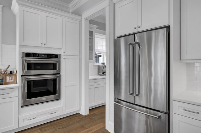 1098 Reserve Ln, Awendaw, SC 29429 - kitchen featuring appliances with stainless steel finishes, ornamental molding, tasteful backsplash, light countertops, and white cabinetry