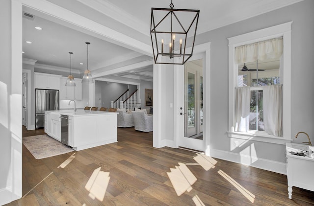 1098 Reserve Ln, Awendaw, SC 29429 - kitchen featuring stainless steel appliances, open floor plan, light countertops, white cabinetry, and a kitchen island with sink