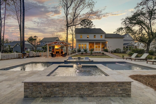 1098 Reserve Ln, Awendaw, SC 29429 - pool at dusk with a gazebo, an in-ground hot tub, a patio, and an outdoor pool