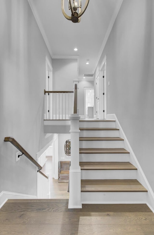 1098 Reserve Ln, Awendaw, SC 29429 - staircase with crown molding, wood finished floors, and a chandelier