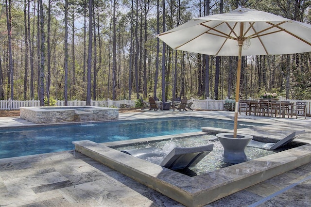1098 Reserve Ln, Awendaw, SC 29429 - view of swimming pool with a pool with connected hot tub, a fenced backyard, and a forest view