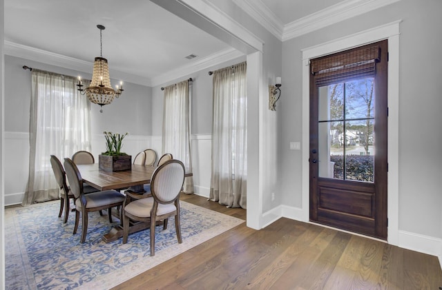 1098 Reserve Ln, Awendaw, SC 29429 - dining space featuring a chandelier, dark wood-style floors, crown molding, and a wainscoted wall