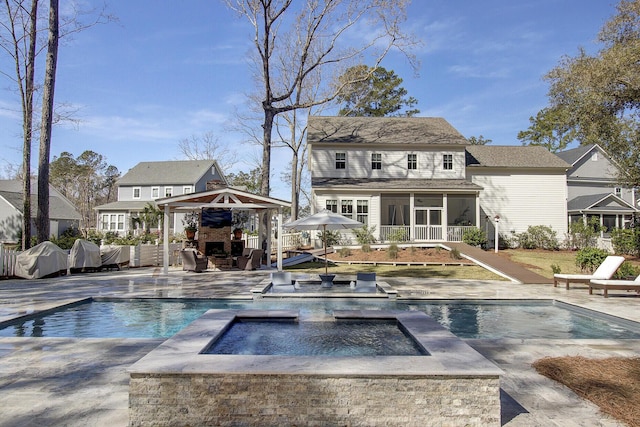 1098 Reserve Ln, Awendaw, SC 29429 - rear view of property with a fireplace, an in-ground hot tub, a sunroom, a patio, and an outdoor pool