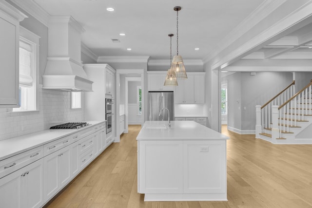 1098 Reserve Ln, Awendaw, SC 29429 - kitchen featuring stainless steel appliances, light countertops, an island with sink, white cabinetry, and recessed lighting