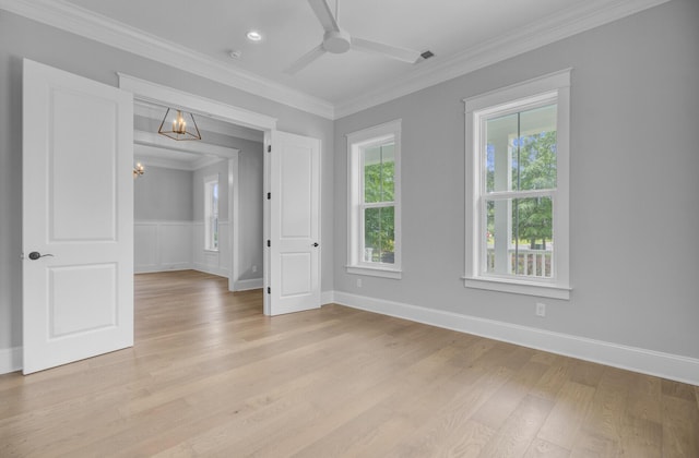 1098 Reserve Ln, Awendaw, SC 29429 - empty room featuring a chandelier, light wood-type flooring, a ceiling fan, and crown molding