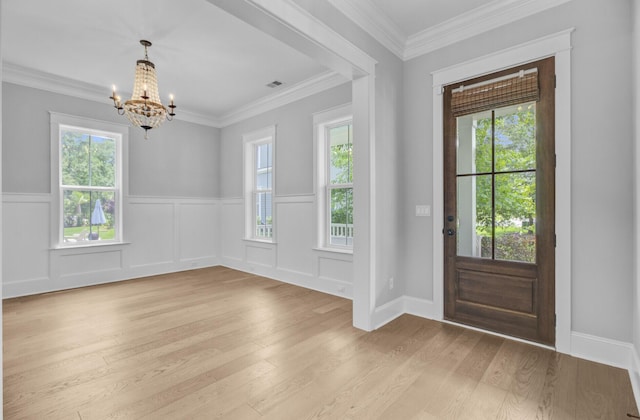 1098 Reserve Ln, Awendaw, SC 29429 - entrance foyer featuring a chandelier, light wood-style flooring, a wainscoted wall, and crown molding