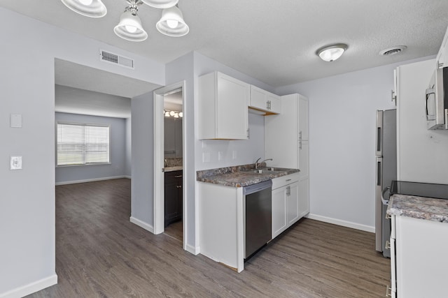 107 Hickory Ln Unit C, Ladson, SC 29456 - kitchen featuring appliances with stainless steel finishes, a chandelier, dark wood finished floors, white cabinets, and a textured ceiling