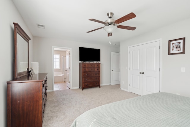 bedroom with baseboards, a closet, visible vents, and light colored carpet