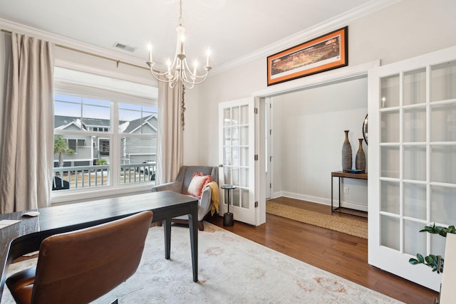 office space with an inviting chandelier, hardwood / wood-style floors, ornamental molding, and french doors