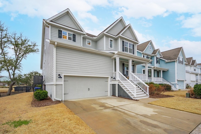 view of front of property with a garage, covered porch, and a front lawn