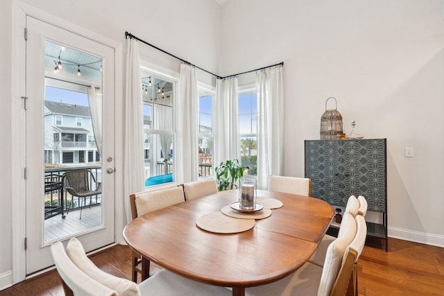 dining space with dark hardwood / wood-style flooring and a wealth of natural light