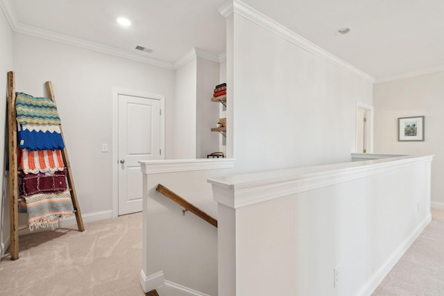 hallway featuring ornamental molding and light carpet