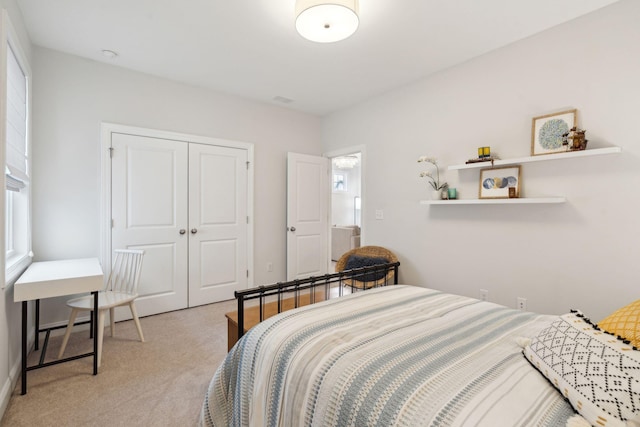 bedroom with light colored carpet and a closet