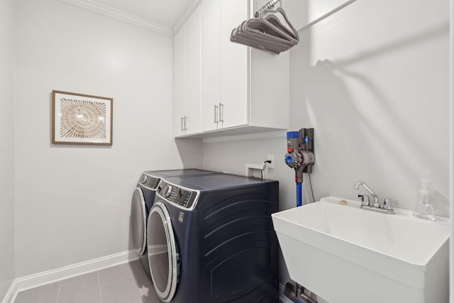 clothes washing area with sink, cabinets, light tile patterned floors, independent washer and dryer, and crown molding