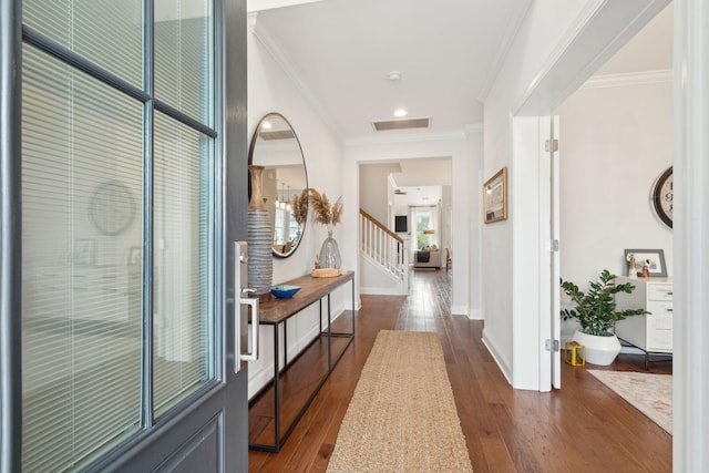 hall featuring ornamental molding and dark hardwood / wood-style floors