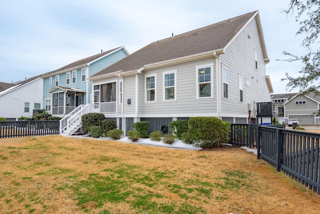 rear view of house with a yard