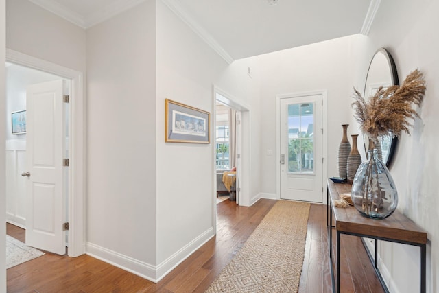 foyer entrance featuring hardwood / wood-style floors and crown molding