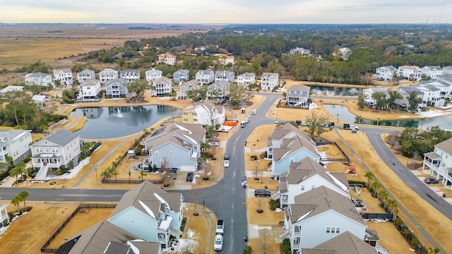 aerial view at dusk featuring a water view