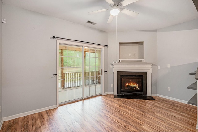 unfurnished living room with ceiling fan and light hardwood / wood-style flooring