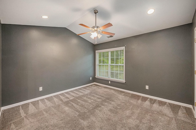 empty room featuring ceiling fan, lofted ceiling, and carpet flooring