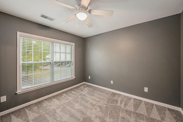 carpeted spare room with ceiling fan