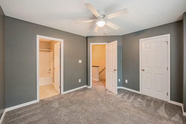 unfurnished bedroom featuring ensuite bathroom, light carpet, and ceiling fan