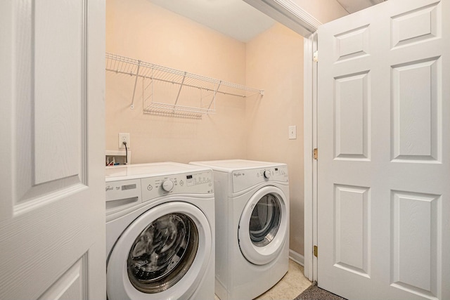 washroom with washing machine and clothes dryer