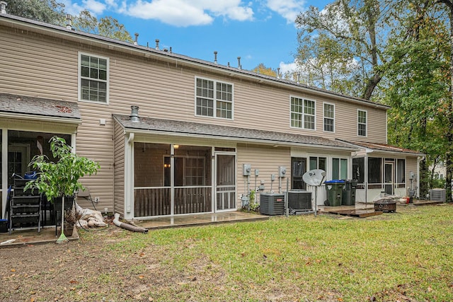 back of property featuring a yard, central AC, and a sunroom