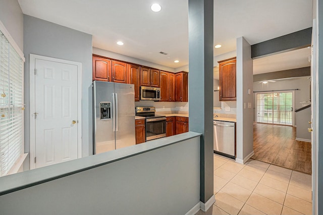 kitchen featuring light tile patterned floors and stainless steel appliances