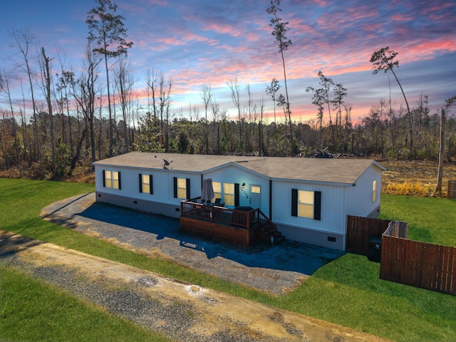 view of front of home featuring crawl space, a wooden deck, fence, and a front yard