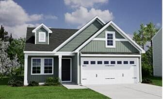 view of front of property with a garage and a front lawn