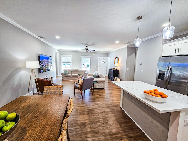 kitchen featuring stainless steel refrigerator with ice dispenser, white cabinetry, hanging light fixtures, light stone countertops, and dark wood-type flooring