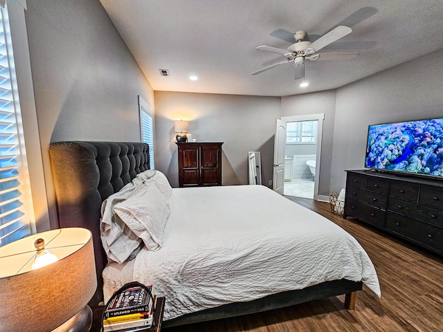 bedroom with ceiling fan, ensuite bath, and wood-type flooring