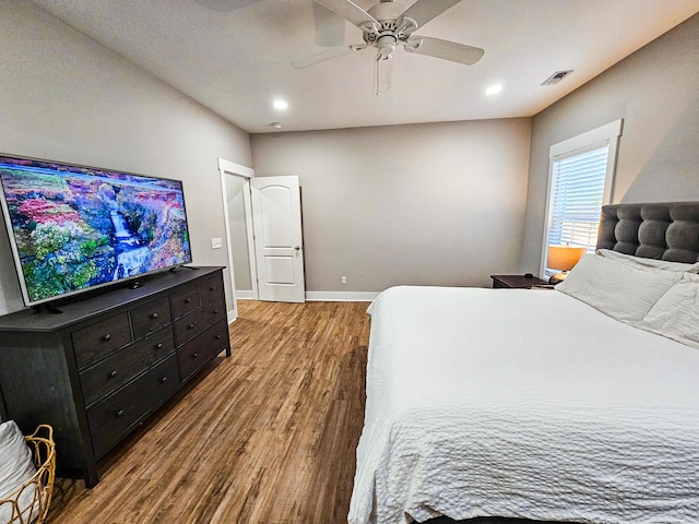 bedroom with ceiling fan and hardwood / wood-style floors