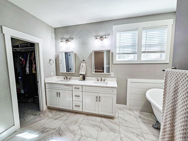 bathroom with a tub and vanity