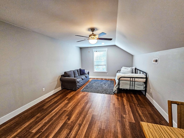 unfurnished bedroom featuring ceiling fan, dark hardwood / wood-style flooring, and lofted ceiling