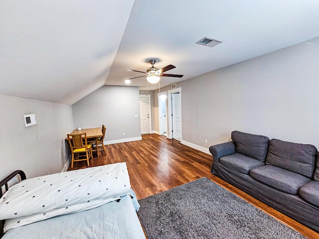 living room featuring ceiling fan, dark hardwood / wood-style floors, and vaulted ceiling