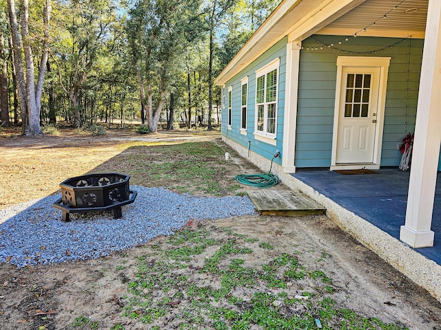 view of yard with an outdoor fire pit