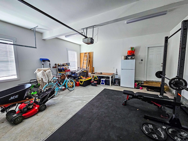 garage with a garage door opener and white refrigerator