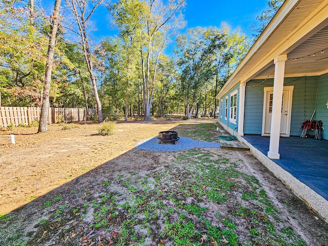 view of yard with an outdoor fire pit and a patio