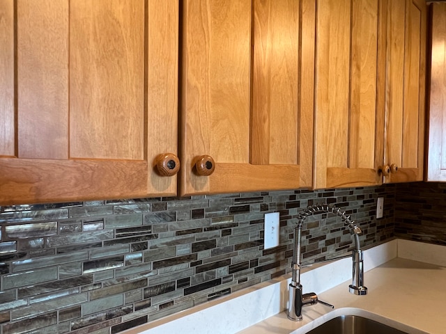 interior details featuring tasteful backsplash and sink