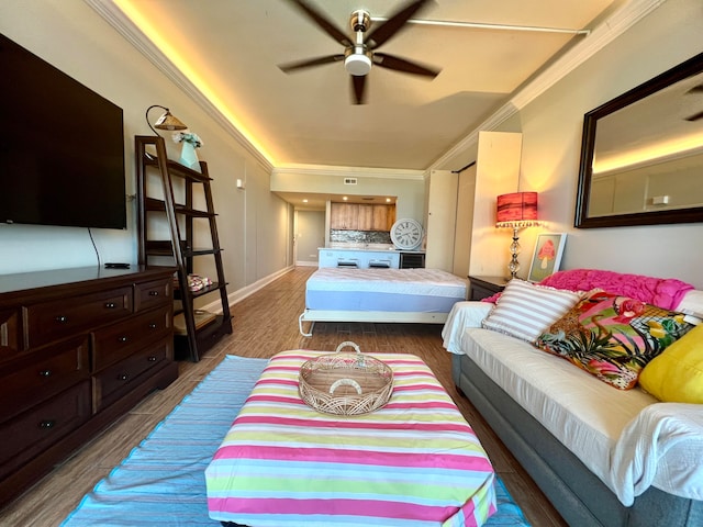 bedroom featuring crown molding, hardwood / wood-style floors, and ceiling fan