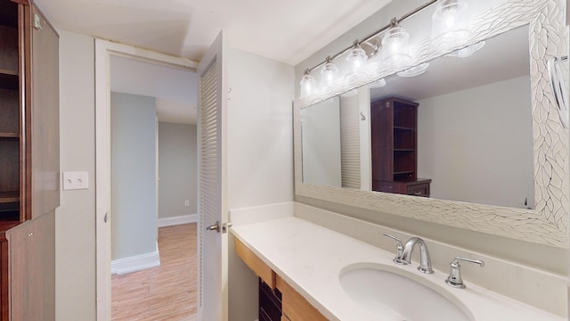 bathroom with vanity and wood-type flooring