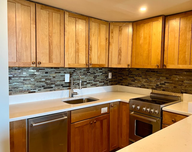 kitchen featuring appliances with stainless steel finishes, backsplash, and sink