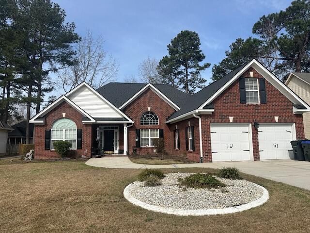 view of front of property with a front lawn and a garage