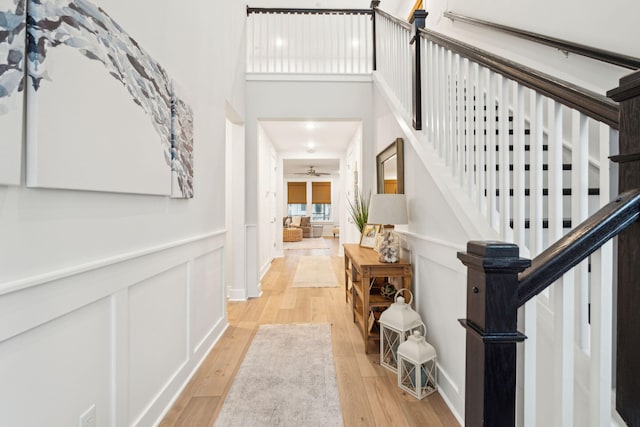 entrance foyer with ceiling fan and light wood-type flooring