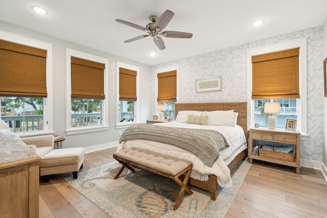 bedroom with ceiling fan and light hardwood / wood-style flooring