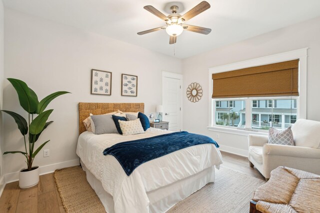 bedroom with light hardwood / wood-style flooring and ceiling fan