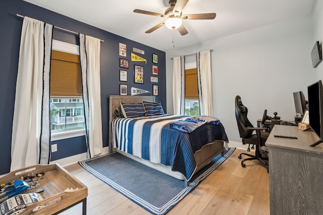 bedroom featuring multiple windows, ceiling fan, and light hardwood / wood-style floors